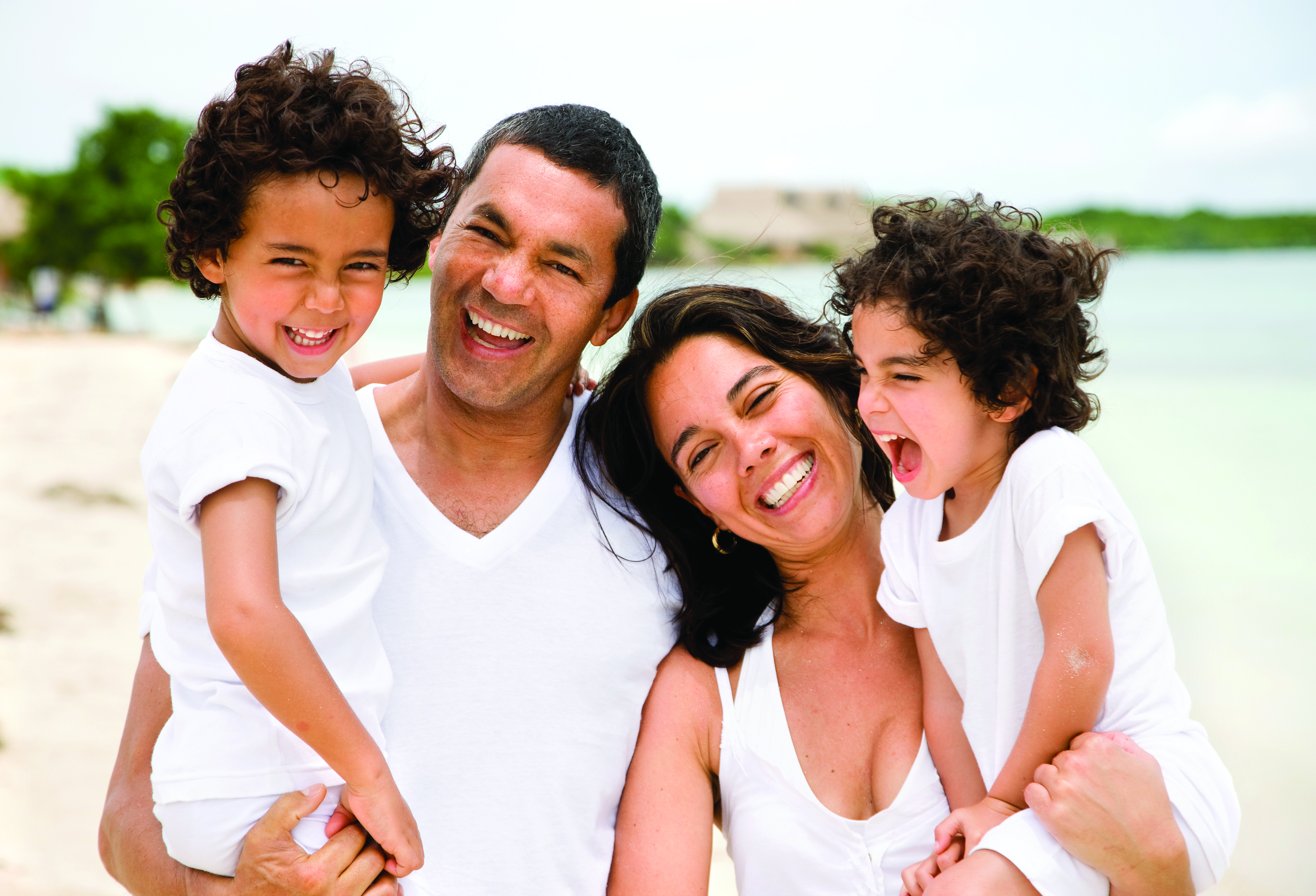 family with kids on beach smiling, Buffalo, NY general dentistry